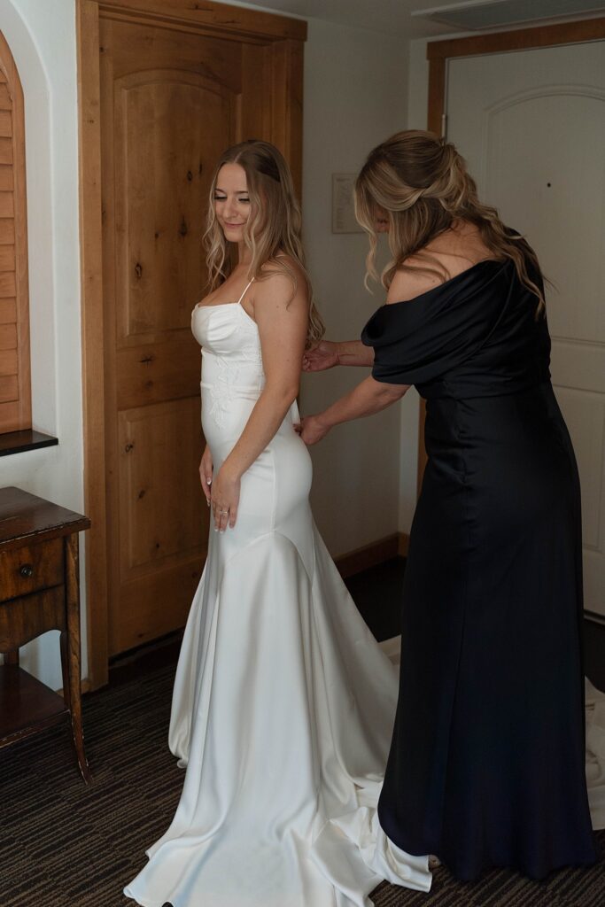 mom helping bride into her dress. lake tahoe wedding photographer videographer. 4JOY media