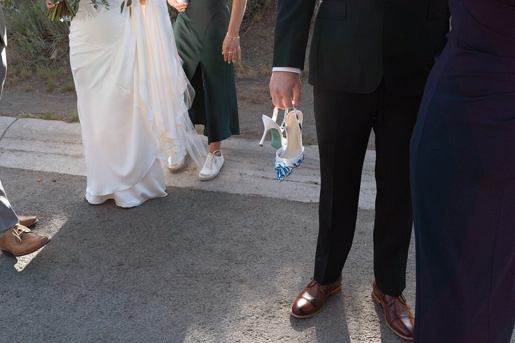 groom holding bride's shoes. lake tahoe wedding elopement photographer videographer. 4JOY media