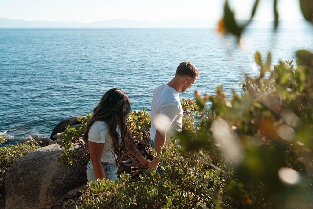 lake tahoe nevada engagement photos climbing on the rocks near sand harbor. lake tahoe engagement photographer