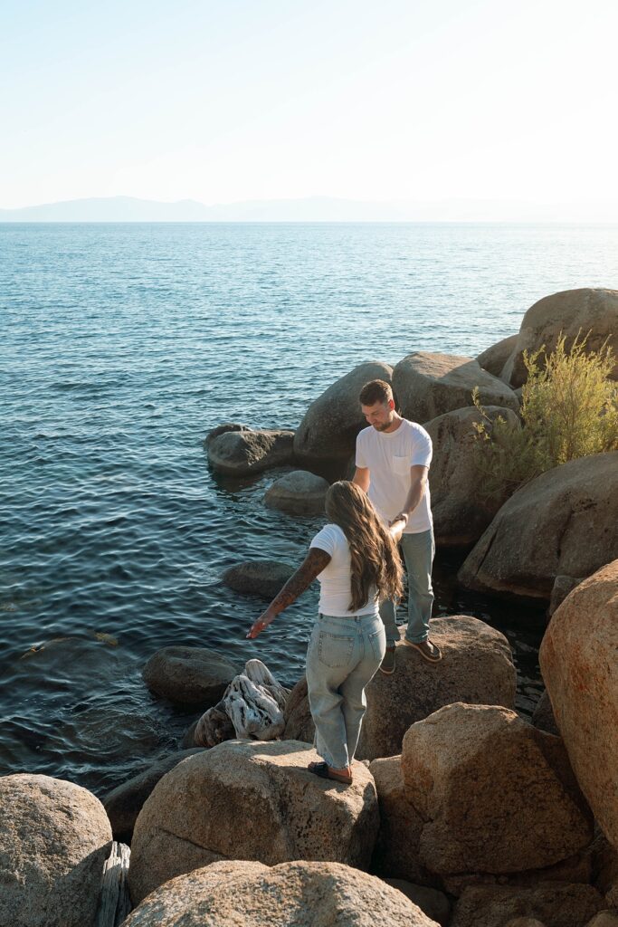 lake tahoe nevada engagement photos climbing on the rocks near sand harbor. lake tahoe engagement photographer