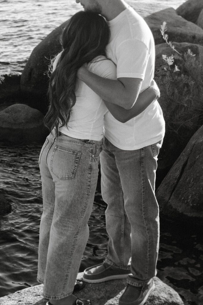 lake tahoe nevada engagement photos climbing on the rocks near sand harbor. lake tahoe engagement photographer