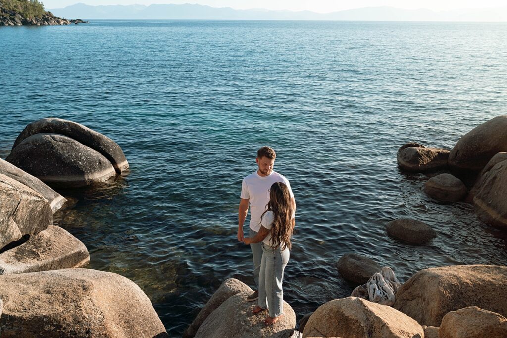 lake tahoe nevada engagement photos climbing on the rocks near sand harbor. lake tahoe engagement photographer