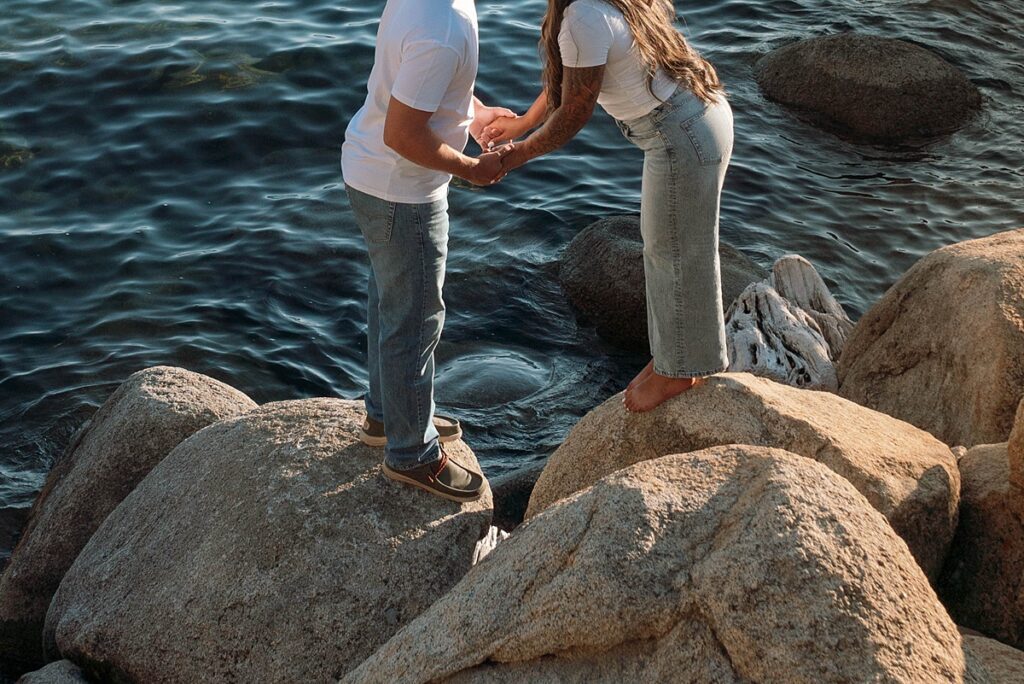 lake tahoe nevada engagement photos climbing on the rocks near sand harbor. lake tahoe engagement photographer