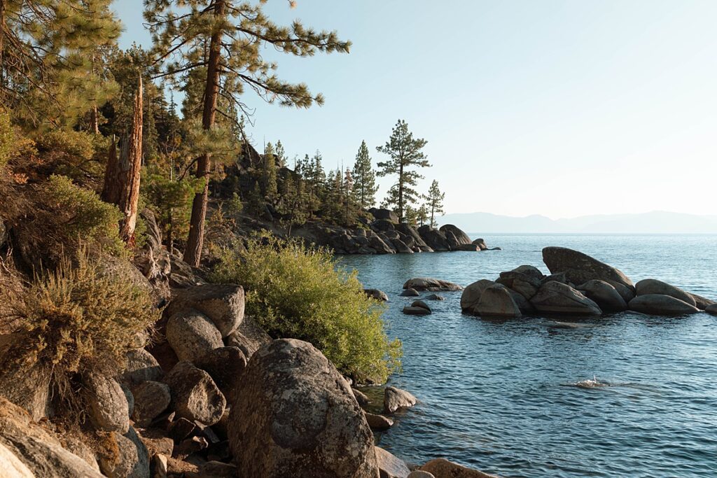 lake tahoe nevada engagement photos climbing on the rocks near sand harbor. lake tahoe engagement photographer