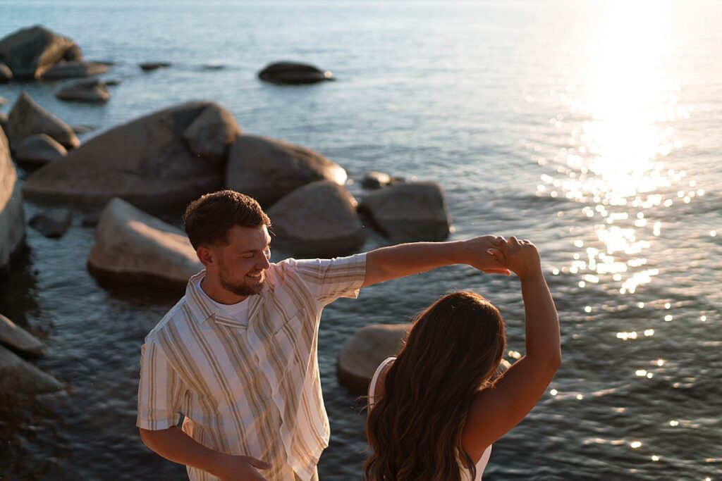 lake tahoe nevada engagement photos climbing on the rocks near sand harbor. lake tahoe engagement photographer