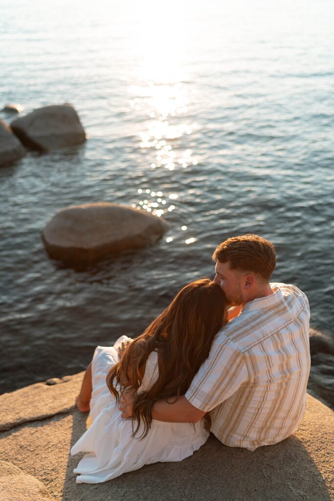 lake tahoe nevada engagement photos climbing on the rocks near sand harbor. lake tahoe engagement photographer