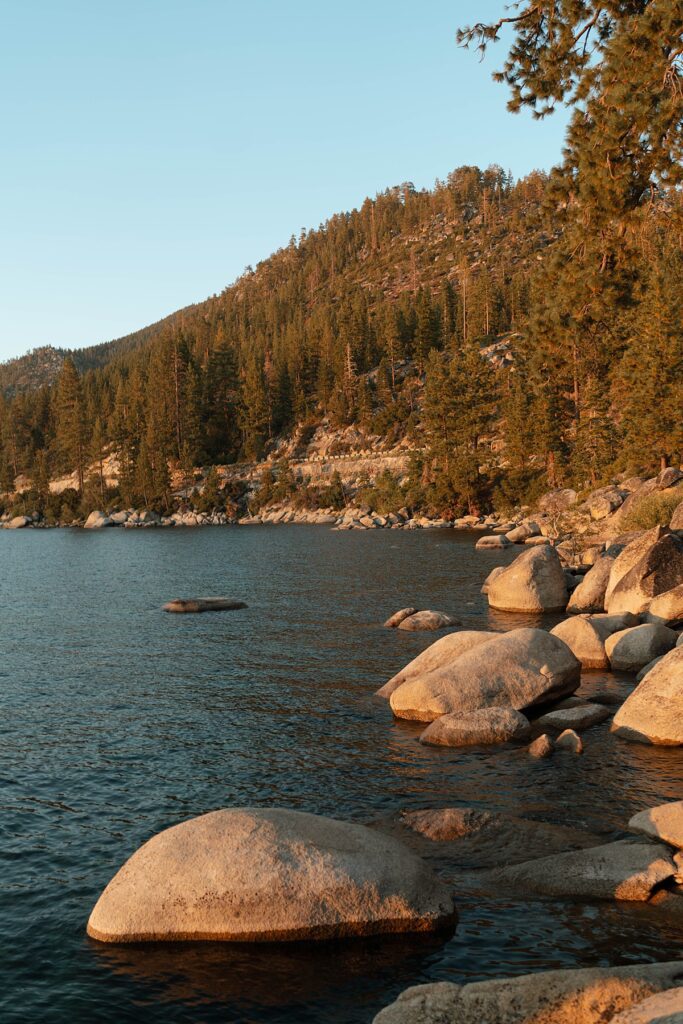 lake tahoe nevada engagement photos climbing on the rocks near sand harbor. lake tahoe engagement photographer