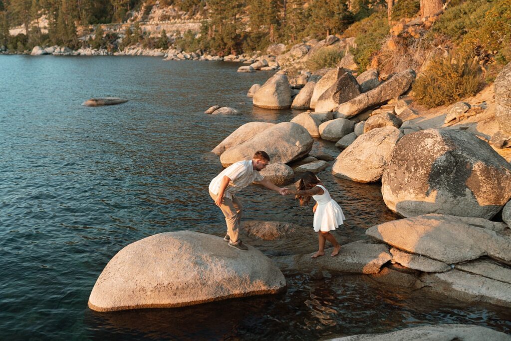 lake tahoe nevada engagement photos climbing on the rocks near sand harbor. lake tahoe engagement photographer