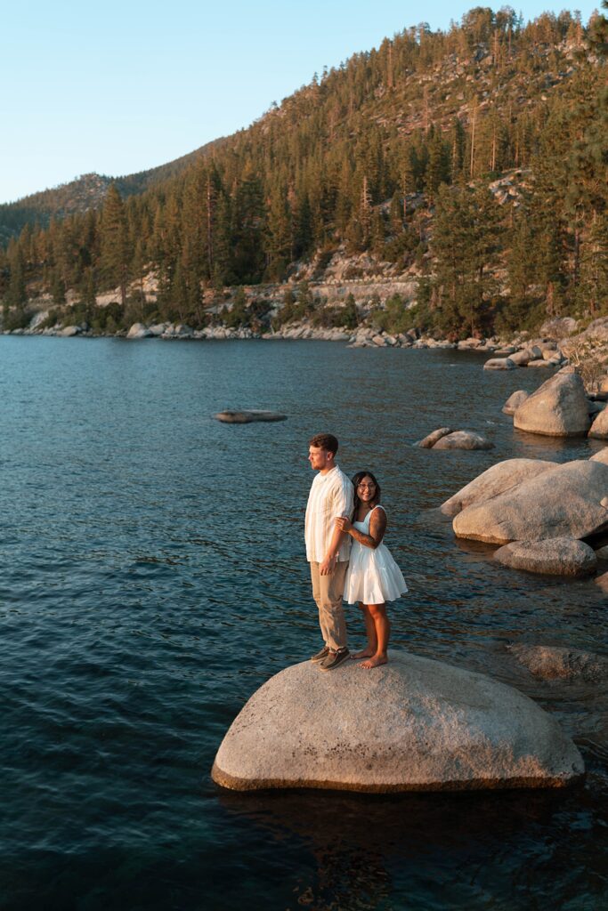 lake tahoe nevada engagement photos climbing on the rocks near sand harbor. lake tahoe engagement photographer