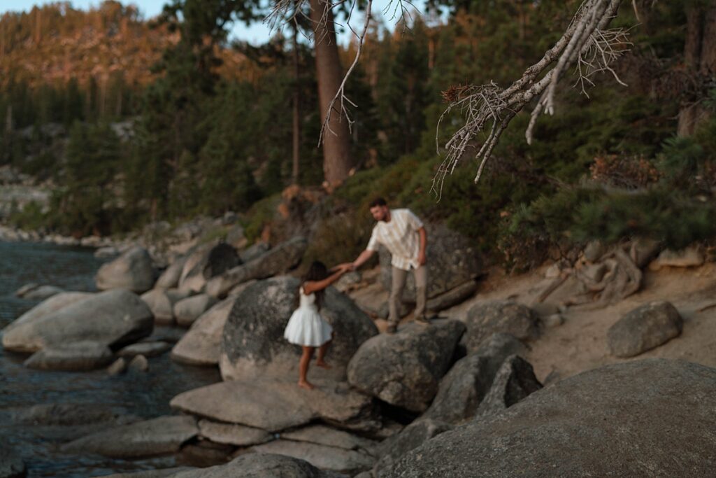 lake tahoe nevada engagement photos climbing on the rocks near sand harbor. lake tahoe engagement photographer