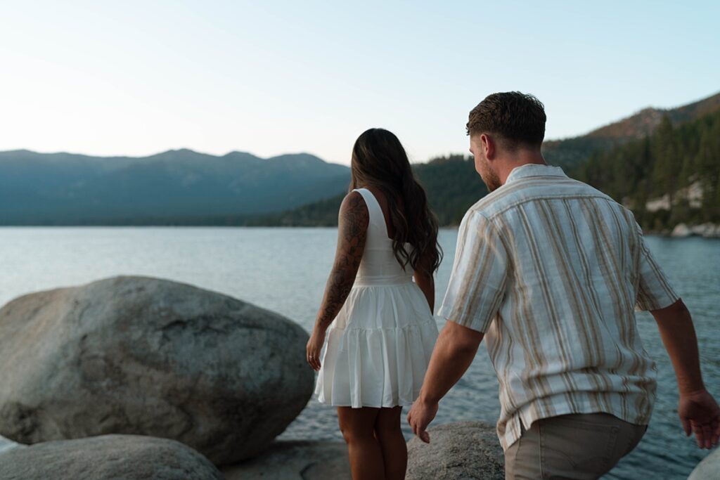 lake tahoe nevada engagement photos climbing on the rocks near sand harbor. lake tahoe engagement photographer