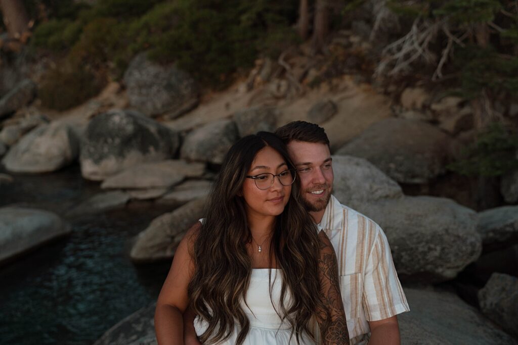lake tahoe nevada engagement photos climbing on the rocks near sand harbor. lake tahoe engagement photographer