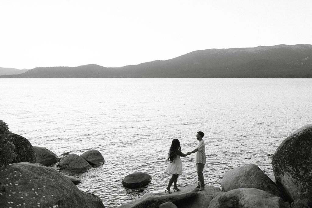 lake tahoe nevada engagement photos climbing on the rocks near sand harbor. lake tahoe engagement photographer