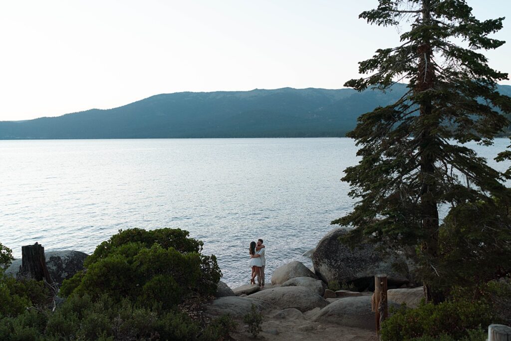 lake tahoe nevada engagement photos climbing on the rocks near sand harbor. lake tahoe engagement photographer