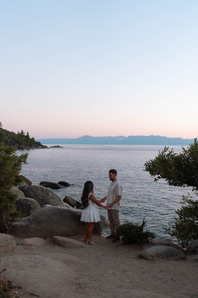 lake tahoe nevada engagement photos climbing on the rocks near sand harbor. lake tahoe engagement photographer