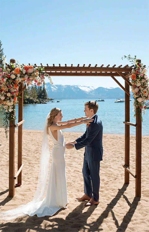 bride and groom first kiss at the wedding ceremony. Roundhill Beach Lake Tahoe Elopement Photographer Videographer 4JOY Media
