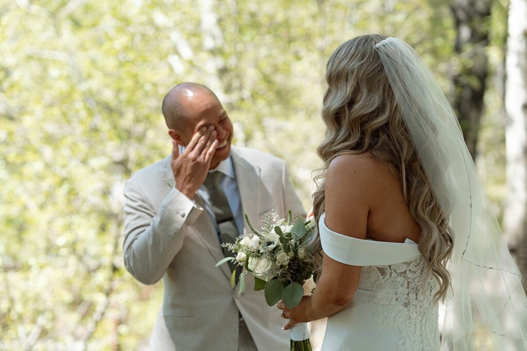 first look bride and groom. groom's reaction. Plumpjack inn Truckee Palisades Lake Tahoe Wedding photographer videographer