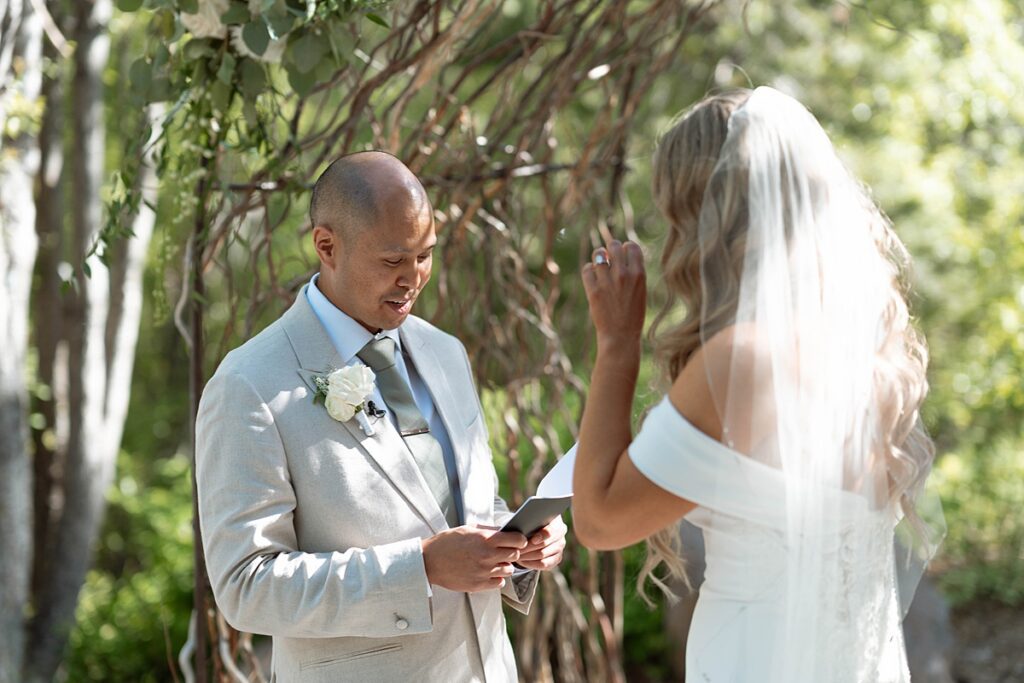 groom reading his vows at the ceremony. Plumpjack inn Truckee Palisades Lake Tahoe Wedding photographer videographer