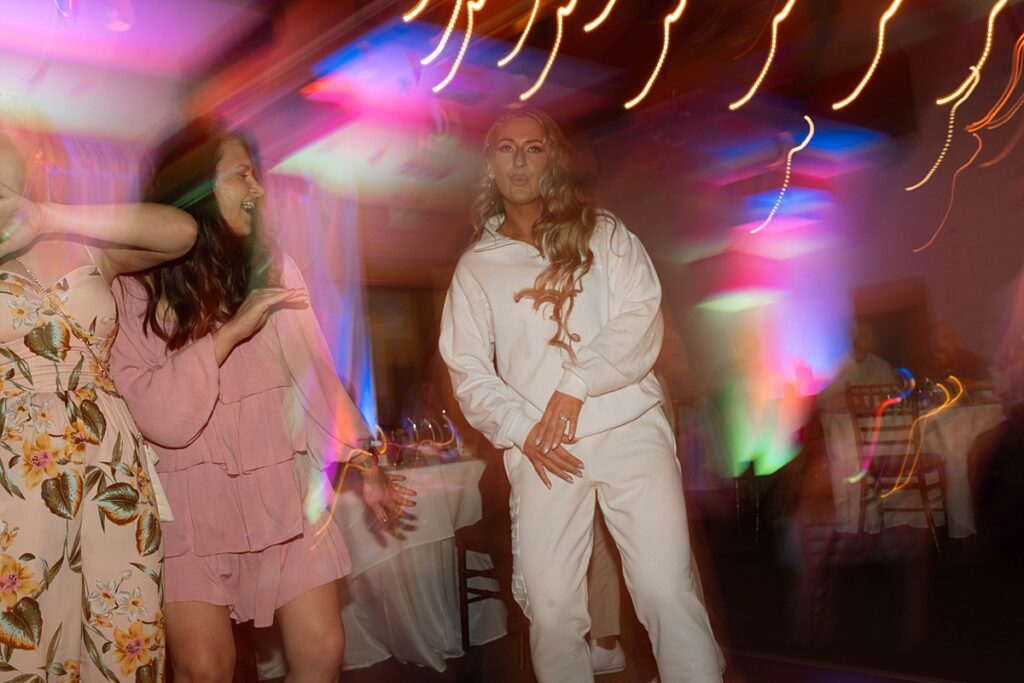 wedding reception dancing. bride's second look is a sweatsuit set. Plumpjack inn Truckee Palisades Lake Tahoe Wedding photographer videographer