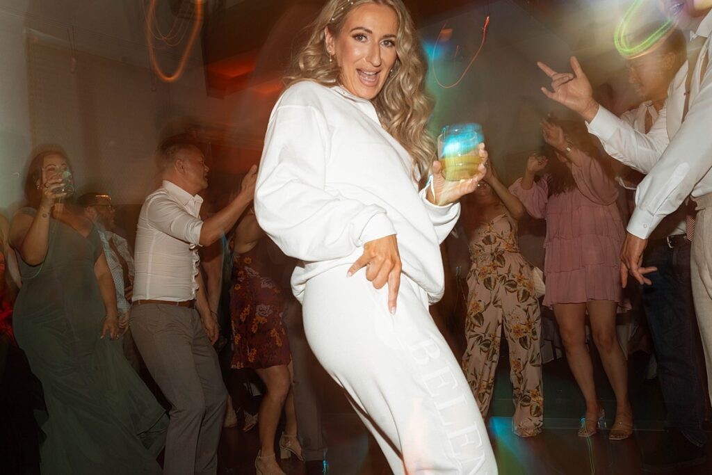 wedding reception dancing. bride's second look is a sweatsuit set. Plumpjack inn Truckee Palisades Lake Tahoe Wedding photographer videographer