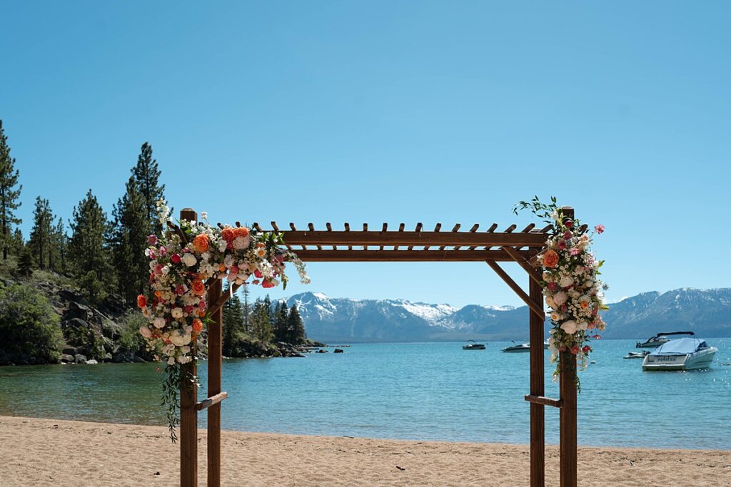 wedding arch for the ceremony. bride and groom ceremony at round hill lake tahoe resort. Roundhill Beach Lake Tahoe Elopement Photographer Videographer 4JOY Media