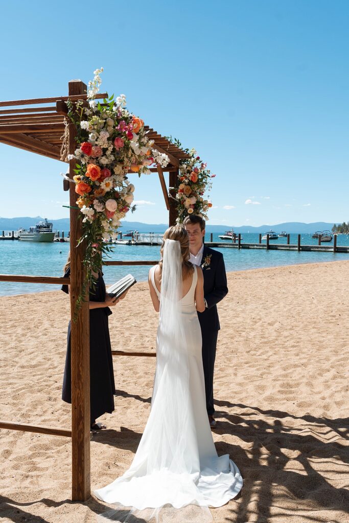 bride and groom at their wedding ceremony. Roundhill Beach Lake Tahoe Elopement Photographer Videographer 4JOY Media