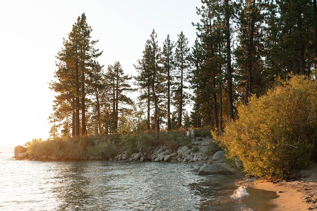 engaged couple scaling the rocks in zephyr cove lake tahoe 