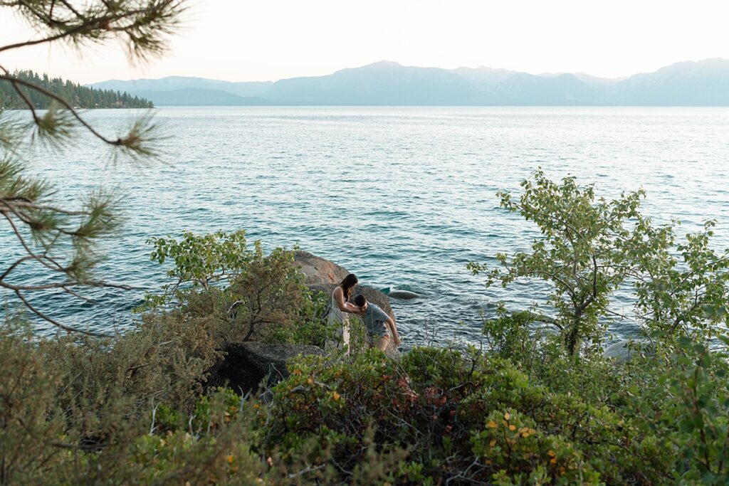 engaged couple scaling rocks at lake tahoe