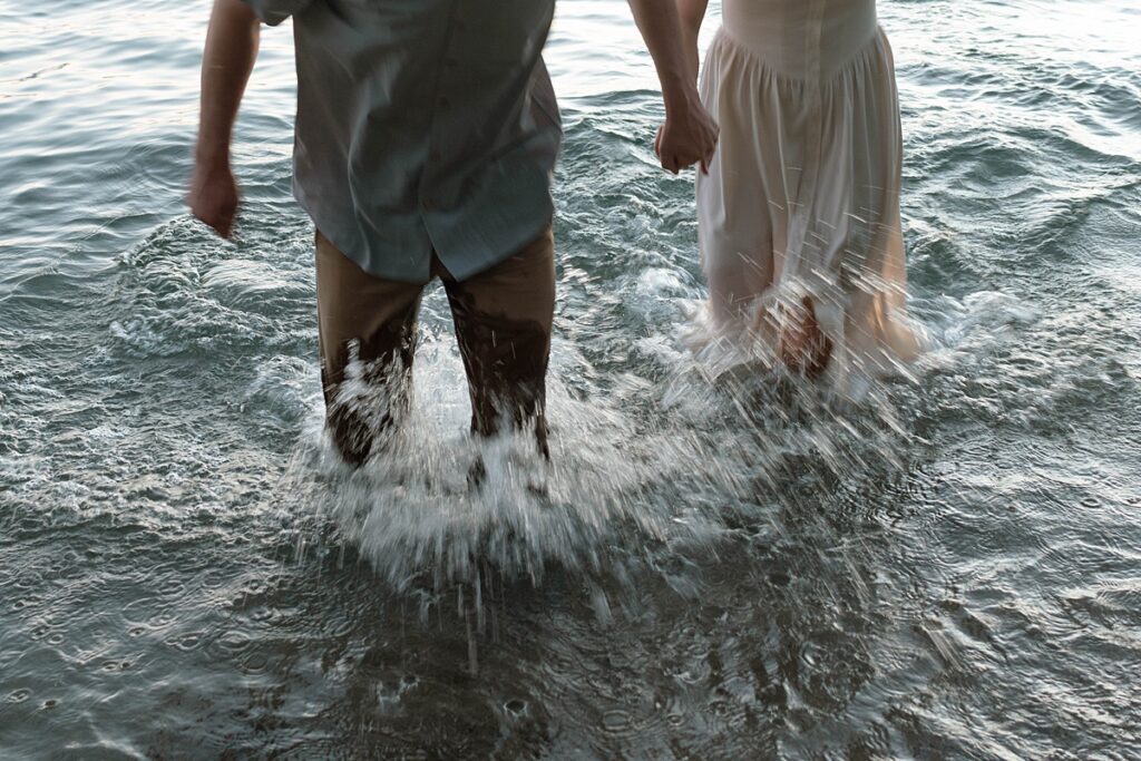 couple playing in lake tahoe during their engagement session