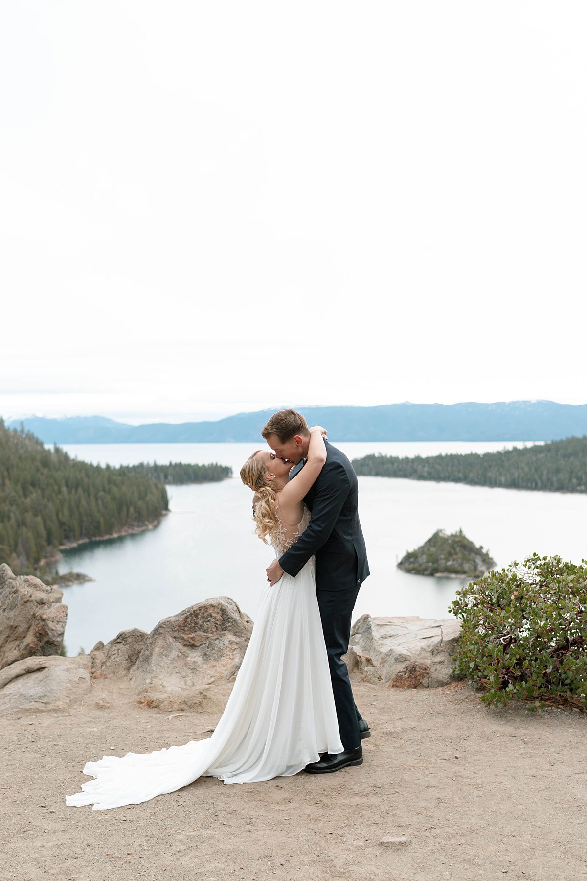 Couple's first kiss at sunrise Elopement ceremony at Emerald Bay captured by Lake Tahoe Wedding Photographer