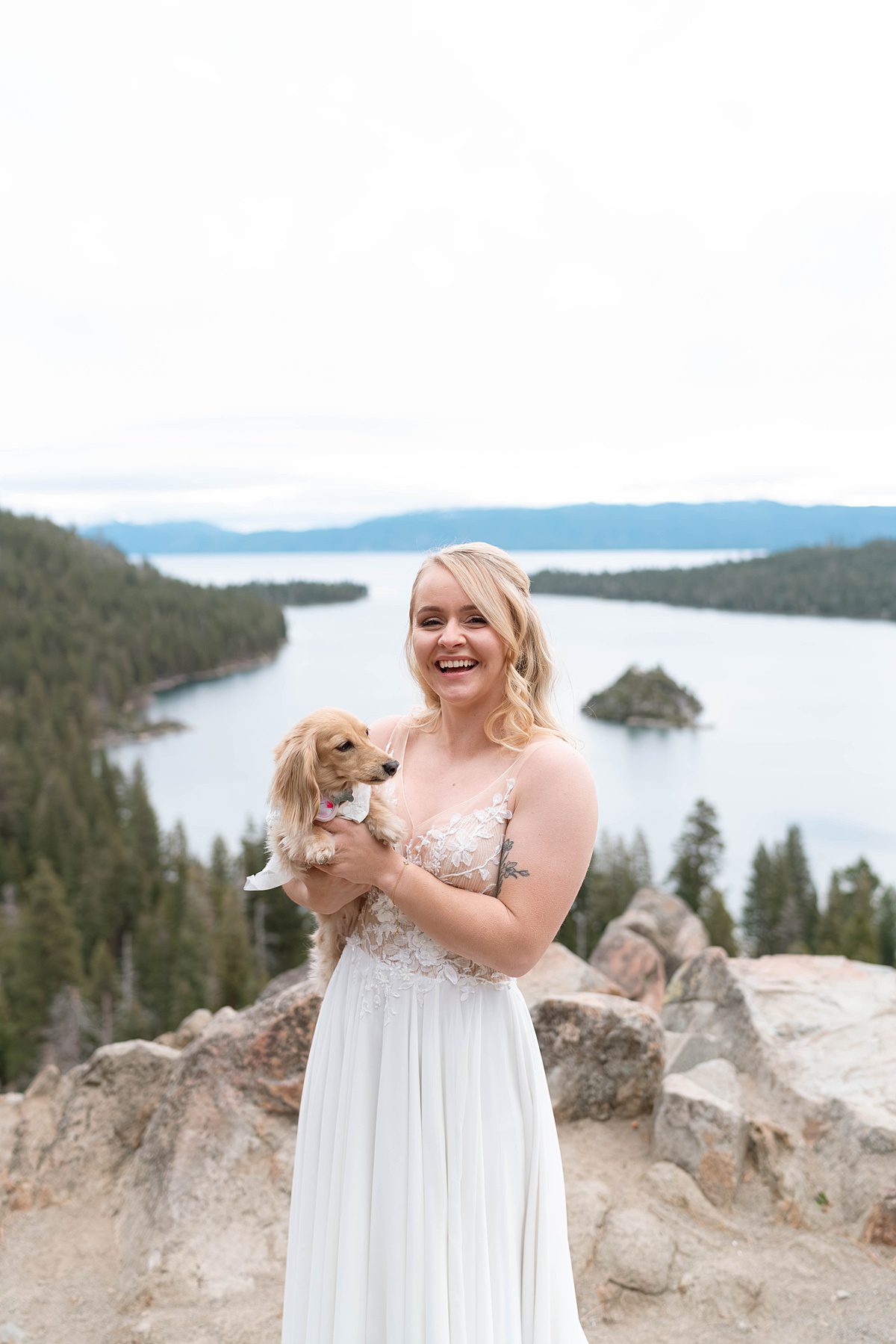 Bride holding her dog during her sunrise Elopement ceremony at Emerald Bay captured by Lake Tahoe Wedding Photographer
